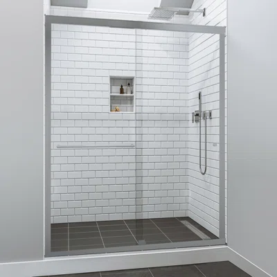 Semi-frameless shower door with a chrome frame and clear glass panels in a modern bathroom with white subway tiles.