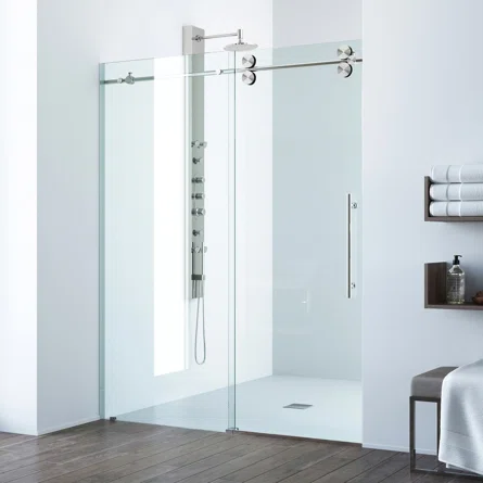 Frameless sliding shower door installation in a modern bathroom with minimal hardware and glass panels.