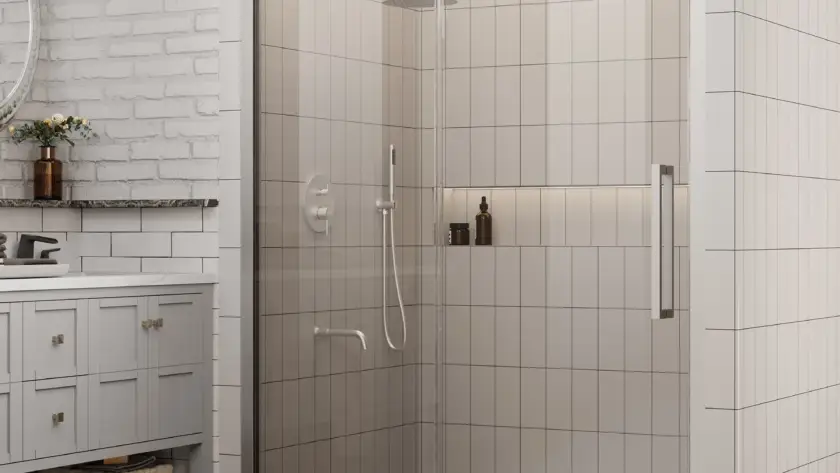 Sliding shower door with clear glass panels and chrome hardware installed in a modern bathroom with tiled walls.