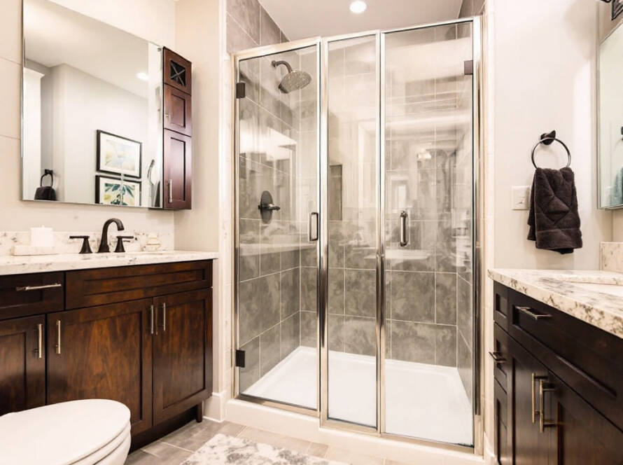 Image of newly installed Bi-fold shower door featuring modern, contemporary design in Boston.