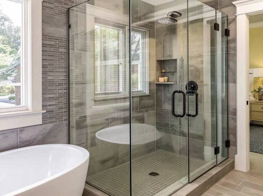 Professional glass installers working on a modern, contemporary style glass shower in Welley, MA.