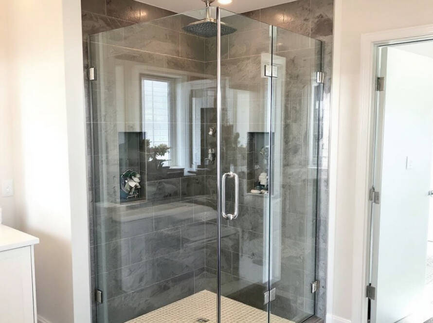 A modern, contemporary frameless glass shower door installation in Medford, MA.