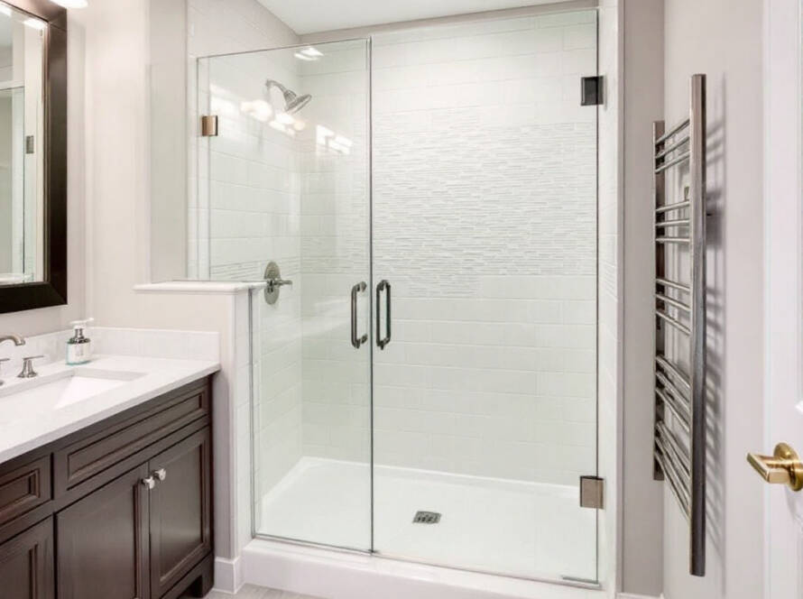 Alt Text: Custom frameless glass shower doors in a modern, contemporary design transforming a bathroom in Boston.